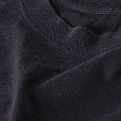 Flat product image of an oversized vintage black t-shirt rib collar neckline.